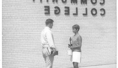 early promotional photo, young man and young woman standing in front of building with GCC title